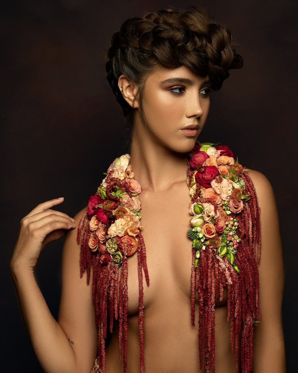 A shawl of roses with long red amaranthus tassels.
